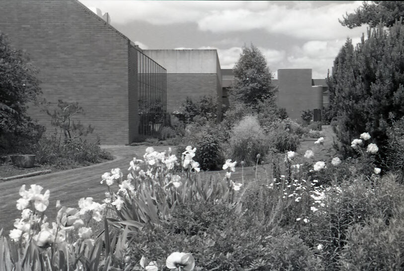 black and white image of the martha springer garden, with sparks athletic center in the background.
